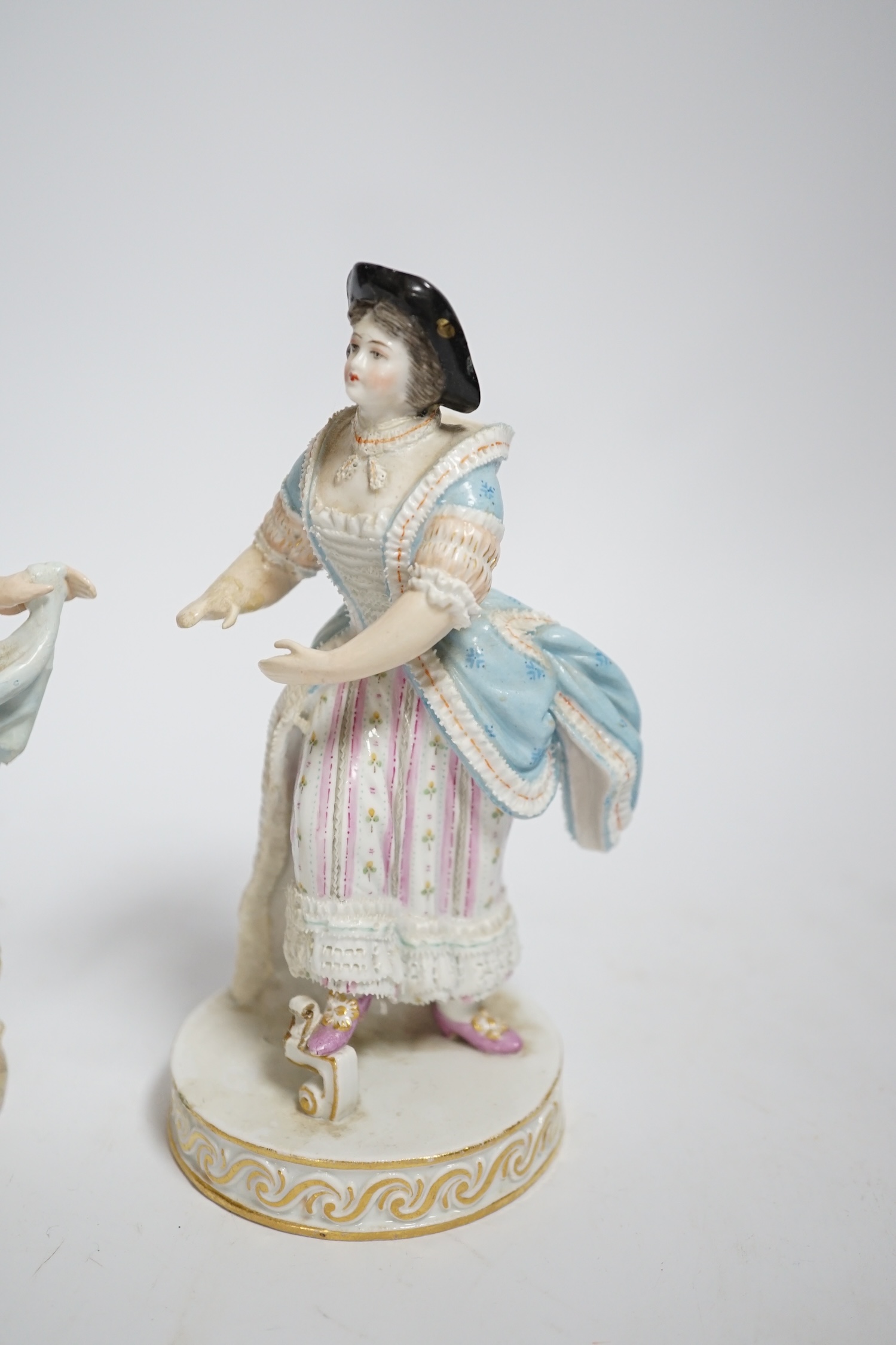 A late Meissen porcelain figure of a young woman wearing a black jacket and floral skirt on circular base, height 15cm and another similar figure (both with restored arms and hands), 15cm high